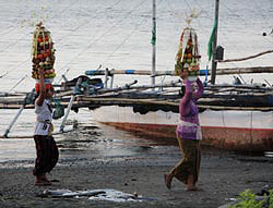 Balinese women bring the offerings to the temple