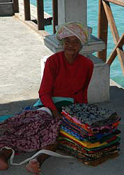 Lady selling sarongs on the pier